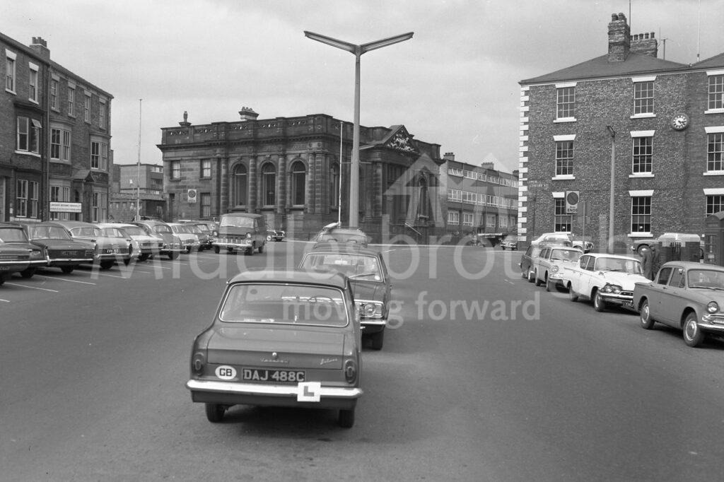Queen's Square in 1969 reveals some now classic cars and different parking conventions to today.